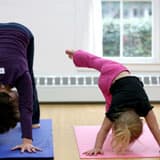 Children practicing yoga poses on mats